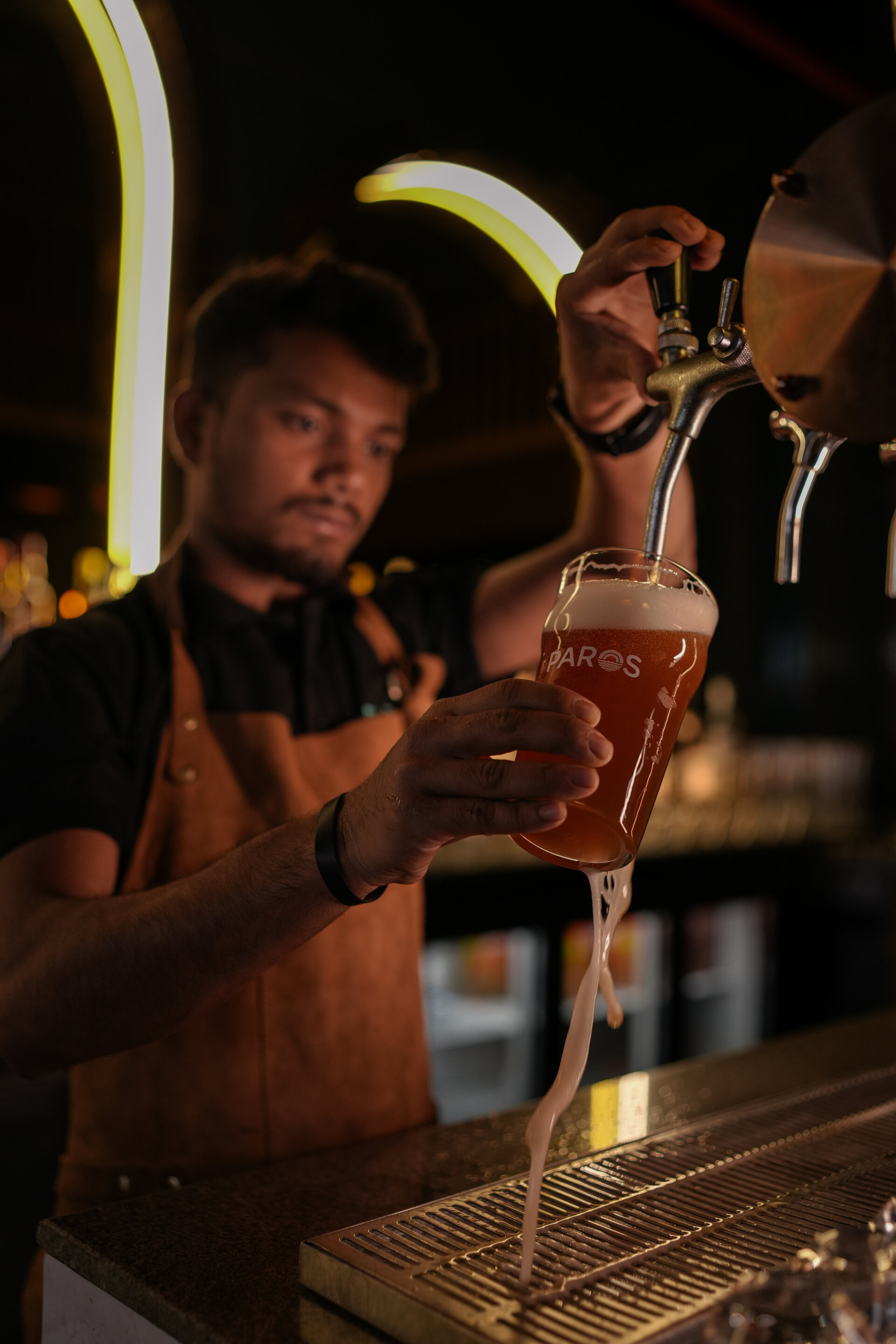 Fresh craft beer being poured at Paros Brewery